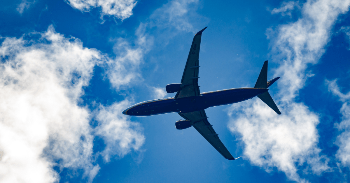 An upward photo of an airplane in flight